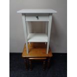 A pine lamp table fitted with a drawer together with a nest of two pine tables