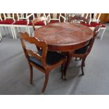 An oval dining table on cabriole legs and four antique chairs