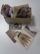 A box of 20th century colour and monochrome postcards,