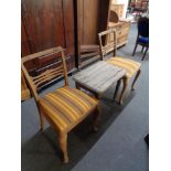 An antique pine side table and a pair of dining chairs