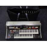 A Technics PCM Sound C 600 portable organ in flight case and a bag of foot pedals