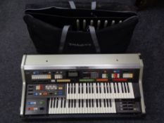 A Technics PCM Sound C 600 portable organ in flight case and a bag of foot pedals