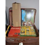 A vintage luggage case of board games and jigsaws
