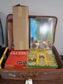 A vintage luggage case of board games and jigsaws