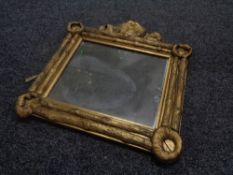 An antique gilt composite wall mirror