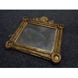 An antique gilt composite wall mirror