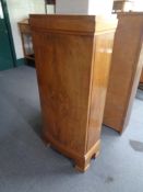 A 20th century walnut single door cabinet