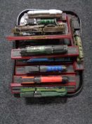 A tray of twelve Atlas model trains on stands