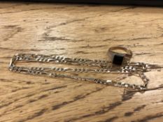 A 9ct gold onyx set ring and a gilt metal chain (2) CONDITION REPORT: Ring 2.8g.