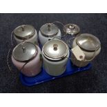 Eight glass lidded biscuit barrels some with hand painted decoration