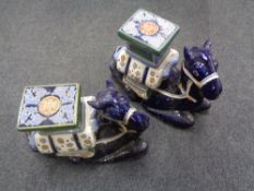 A pair of glazed pottery camel plant stands
