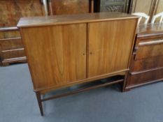 A mid 20th century teak double door sideboard 110 cm x 124.5 cm x 46 cm.