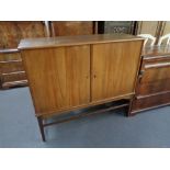 A mid 20th century teak double door sideboard 110 cm x 124.5 cm x 46 cm.