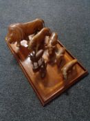 An inlaid mahogany tea tray and seven carved animal figures.