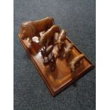 An inlaid mahogany tea tray and seven carved animal figures.