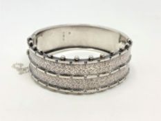 A late Victorian engraved silver bangle,