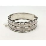 A late Victorian engraved silver bangle,