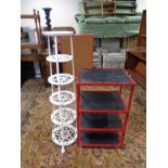 A cast metal six tier pan stand together with a red metal framed shelf
