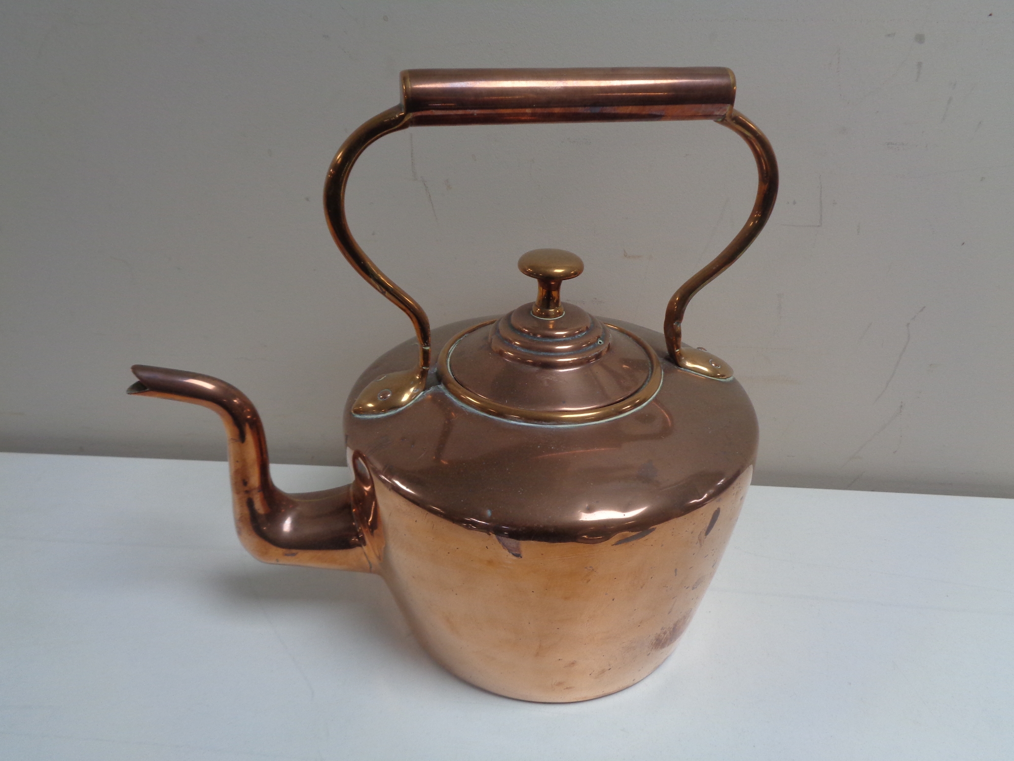 A Victorian copper kettle.