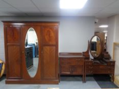 A three piece late Victorian inlaid mahogany bedroom suite