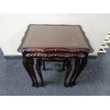 A nest of three inlaid mahogany tables