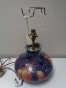 A Moorcroft table lamp, with pomegranate and bird design, height 20 cm.