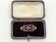 An antique gold amethyst and seed pearl brooch