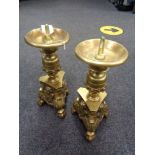 A pair of heavy brass pricket candlesticks on claw and ball feet