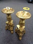 A pair of heavy brass pricket candlesticks on claw and ball feet