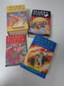 Four Harry Potter books, one bearing J K Rowling signature and three marked First Editions.