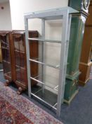 A set of metal and glass five tier shelves