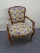 A continental beech framed armchair in tapestry fabric