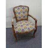 A continental beech framed armchair in tapestry fabric