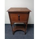 An oak work cabinet on barley twist legs