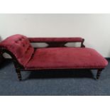 An antique chaise longue in maroon dralon