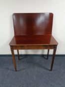 A Victorian mahogany turnover top table on tapered legs