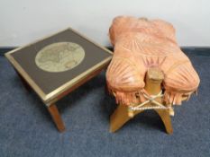 A camel stool and a coffee table depicting a map of the world