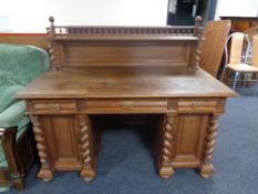 A 20th century oak twin pedestal writing desk fitted three drawers and back shelf