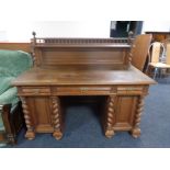 A 20th century oak twin pedestal writing desk fitted three drawers and back shelf