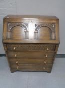 A carved oak bureau