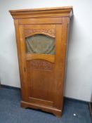 An early 20th century oak hall cupboard