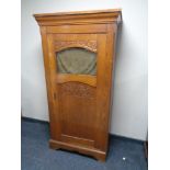 An early 20th century oak hall cupboard