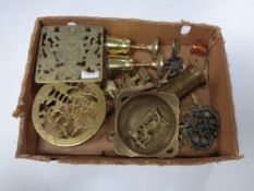 A box of assorted brass ware, trivets, goblets,