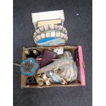 Two boxes of metal bottle cap wall hangings, dog figures, cameras,