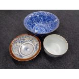 A hand painted blue and white glazed pottery bowl with plated rim together with a further blue and