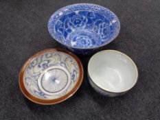 A hand painted blue and white glazed pottery bowl with plated rim together with a further blue and