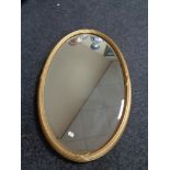 An Edwardian gilt framed oval mirror