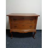 An early 20th century two drawer chest on cabriole legs