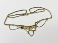 An Edwardian style yellow metal necklace set with synthetic rubies