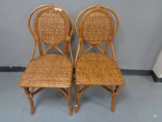 A pair of bamboo and wicker dining chairs